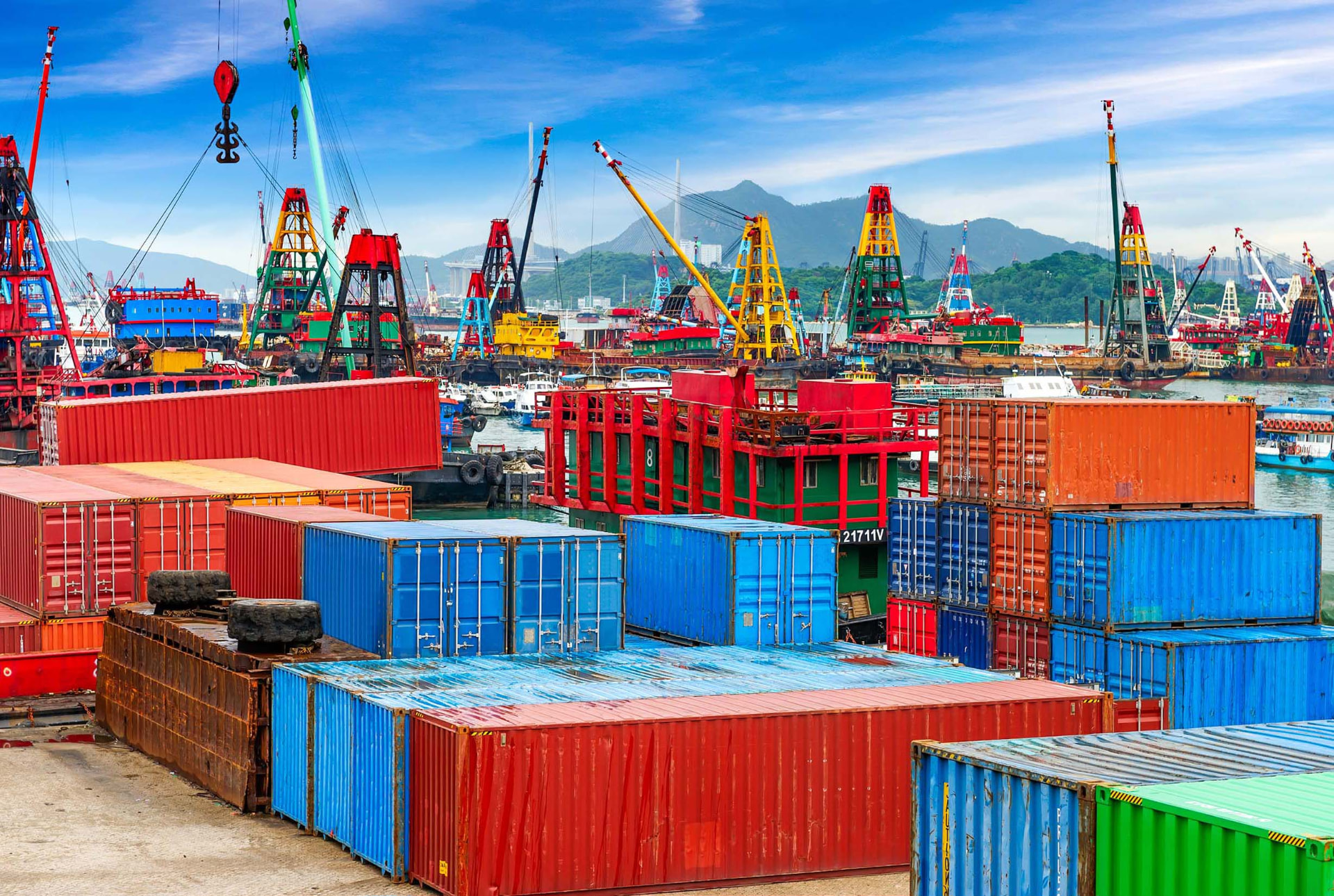 Oroic Agribusiness trading and export — stacked shipping containers and cranes at a busy port terminal.